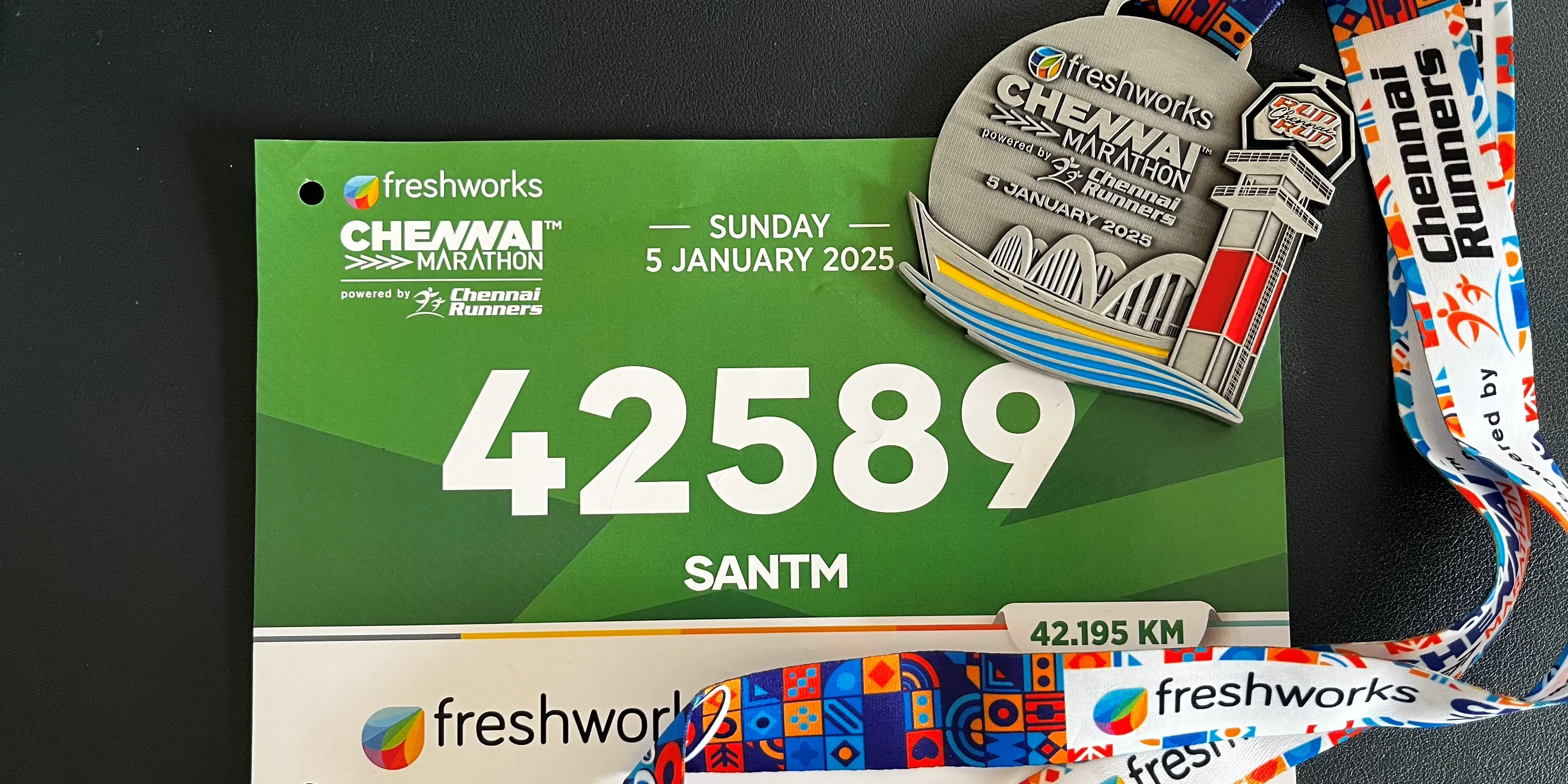 Customary finisher medal and Running BIB of Chennai Marathon 2025